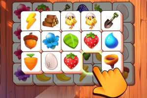 Juego de combinar íconos con imágenes de frutas, vegetales y elementos de granja en una interfaz de madera con una mano tocando la pantalla