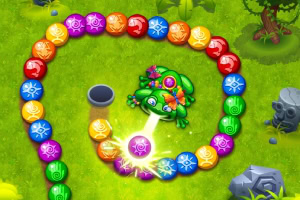 Juego de disparar bolas de colores con una rana verde en un entorno de césped con árboles y rocas